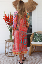 Woman in a colourful viscose-linen boho patchwork midi dress with v-neck collar, button front & 3/4 sleeves.