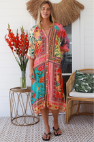 Woman in a colourful viscose-linen boho patchwork midi dress with v-neck collar, button front & 3/4 sleeves.