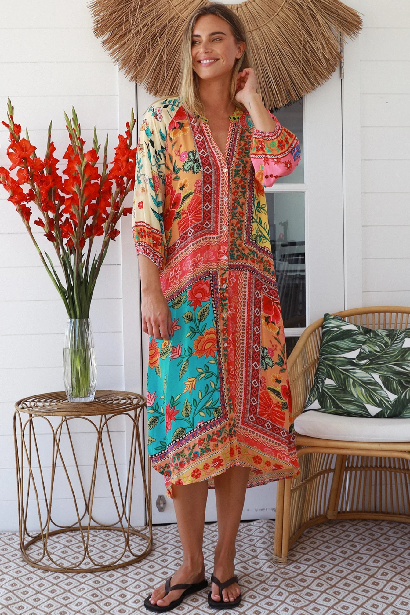 Woman in a colourful viscose-linen boho patchwork midi dress with v-neck collar, button front & 3/4 sleeves.