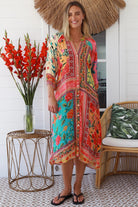 Woman in a colourful viscose-linen boho patchwork midi dress with v-neck collar, button front & 3/4 sleeves.