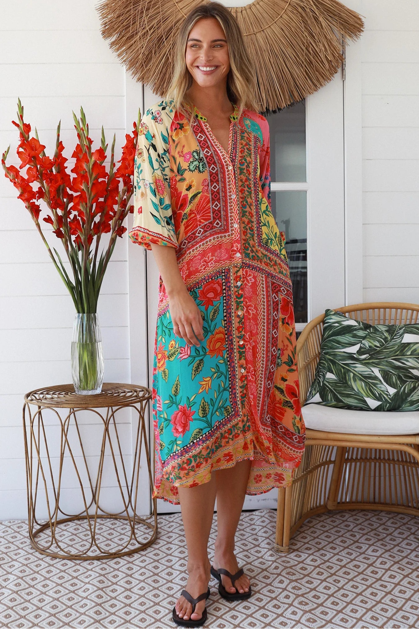 Woman in a colourful viscose-crepe boho patchwork midi dress with v-neck collar, button front & 3/4 sleeves.
