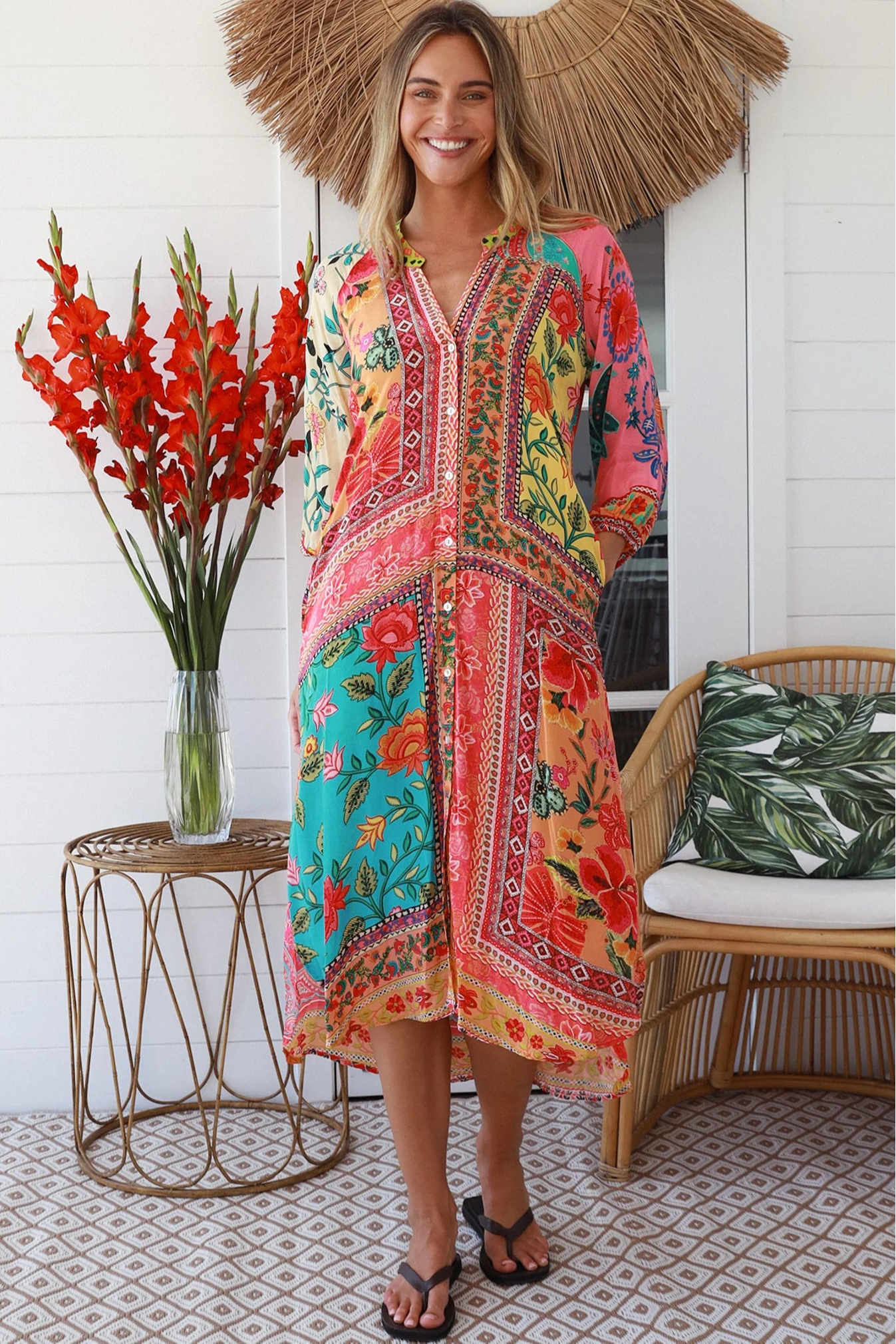 Woman in a colourful viscose-linen boho patchwork midi dress with v-neck collar, button front & 3/4 sleeves.