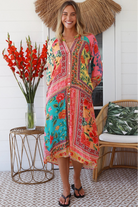 Woman in a colourful viscose-linen boho patchwork midi dress with v-neck collar, button front & 3/4 sleeves.