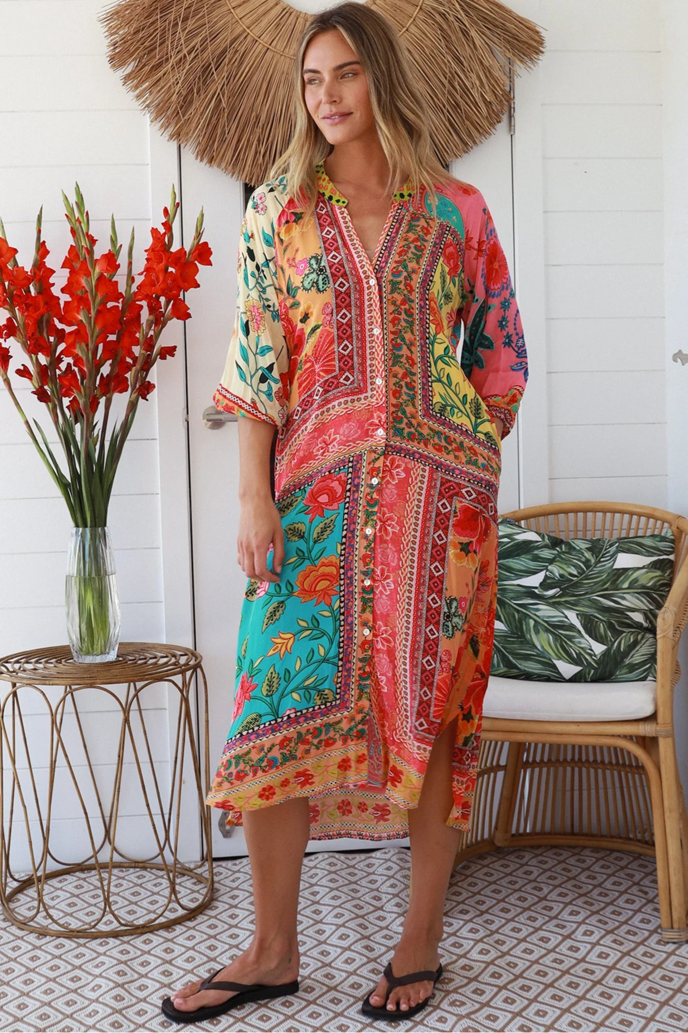 Woman in a colourful viscose-linen boho patchwork midi dress with v-neck collar, button front & 3/4 sleeves.