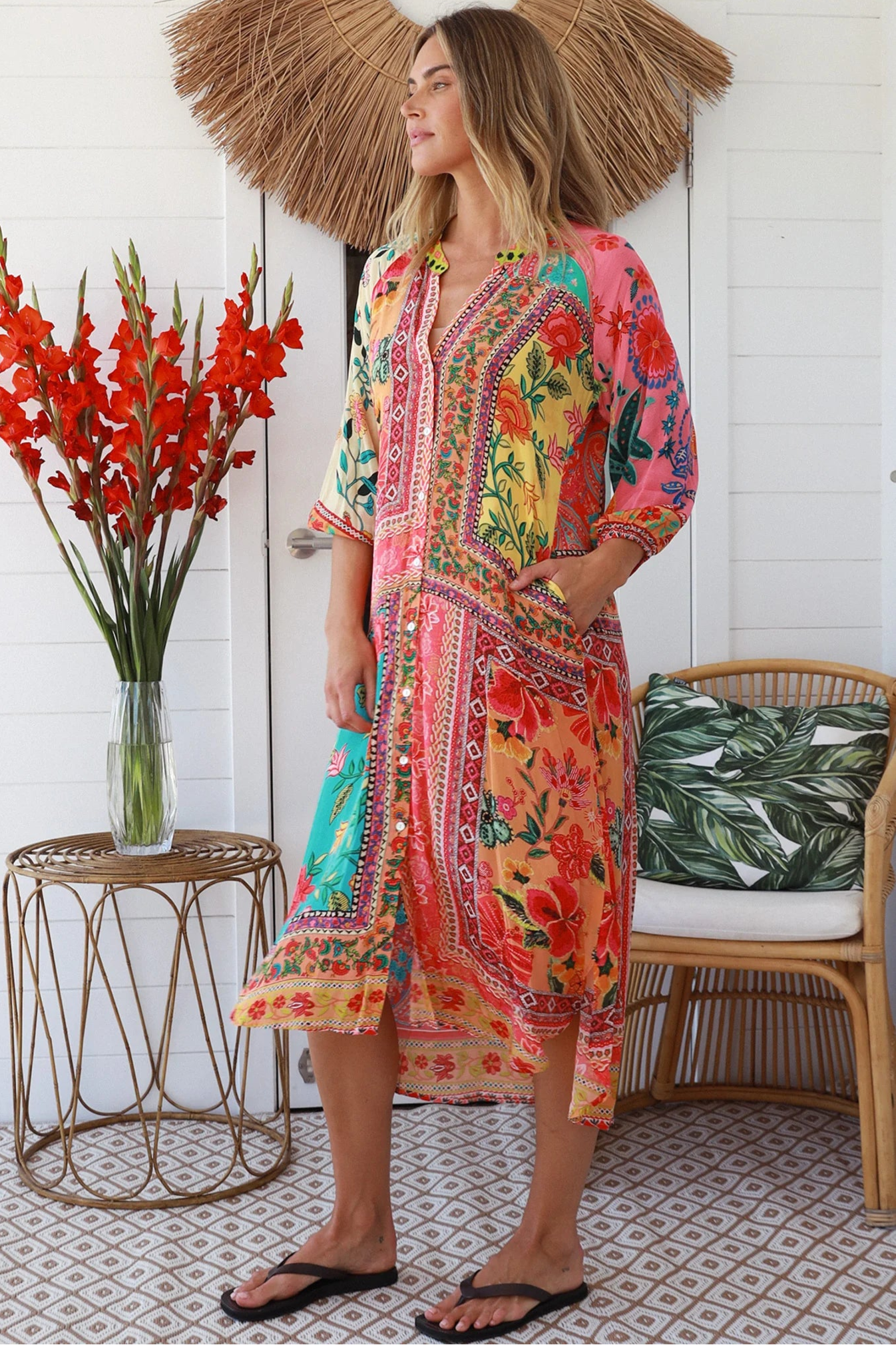 Woman in a colourful viscose-linen boho patchwork midi dress with v-neck collar, button front & 3/4 sleeves.