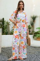 Vintage floral wide-leg pants with elastic waist and soft pastel print in a relaxed boho silhouette