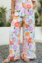 Vintage floral wide-leg pants with elastic waist and soft pastel print in a relaxed boho silhouette