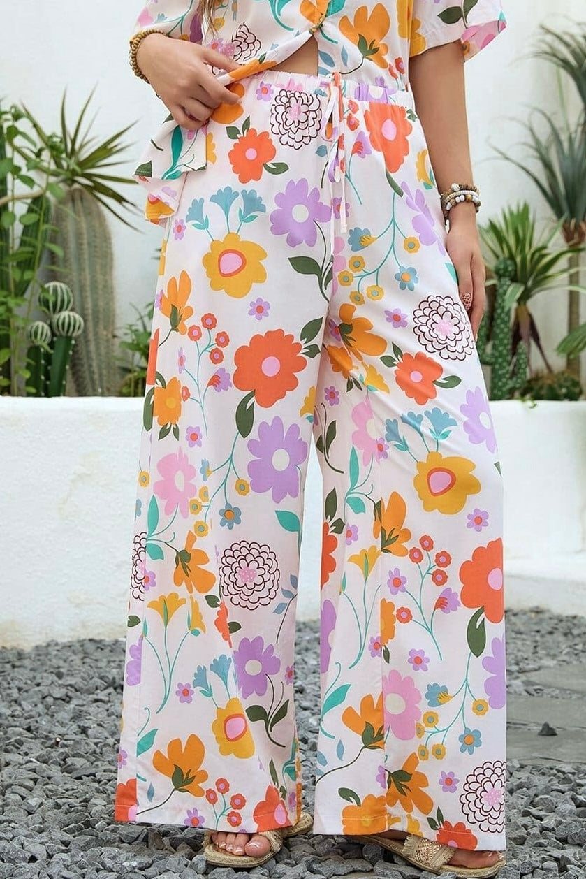 Vintage floral wide-leg pants with elastic waist and soft pastel print in a relaxed boho silhouette