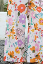 Vintage floral wide-leg pants with elastic waist and soft pastel print in a relaxed boho silhouette