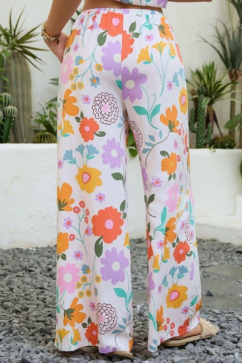 Vintage floral wide-leg pants with elastic waist and soft pastel print in a relaxed boho silhouette