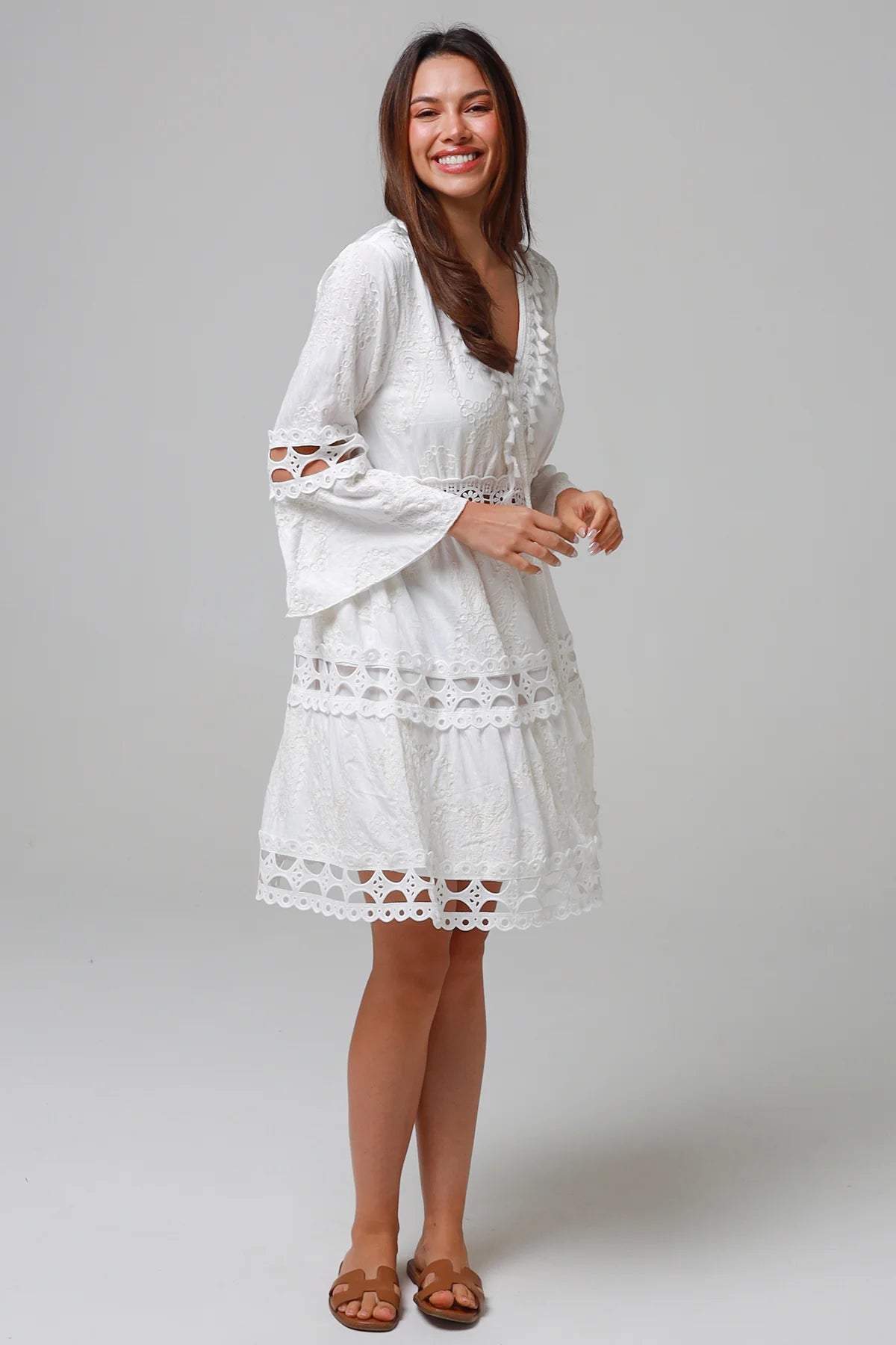 Woman in white embroidered cotton mini dress wit lace sleeves and tiered hem - Sabrina Mini Dress Bohemian Love Runway