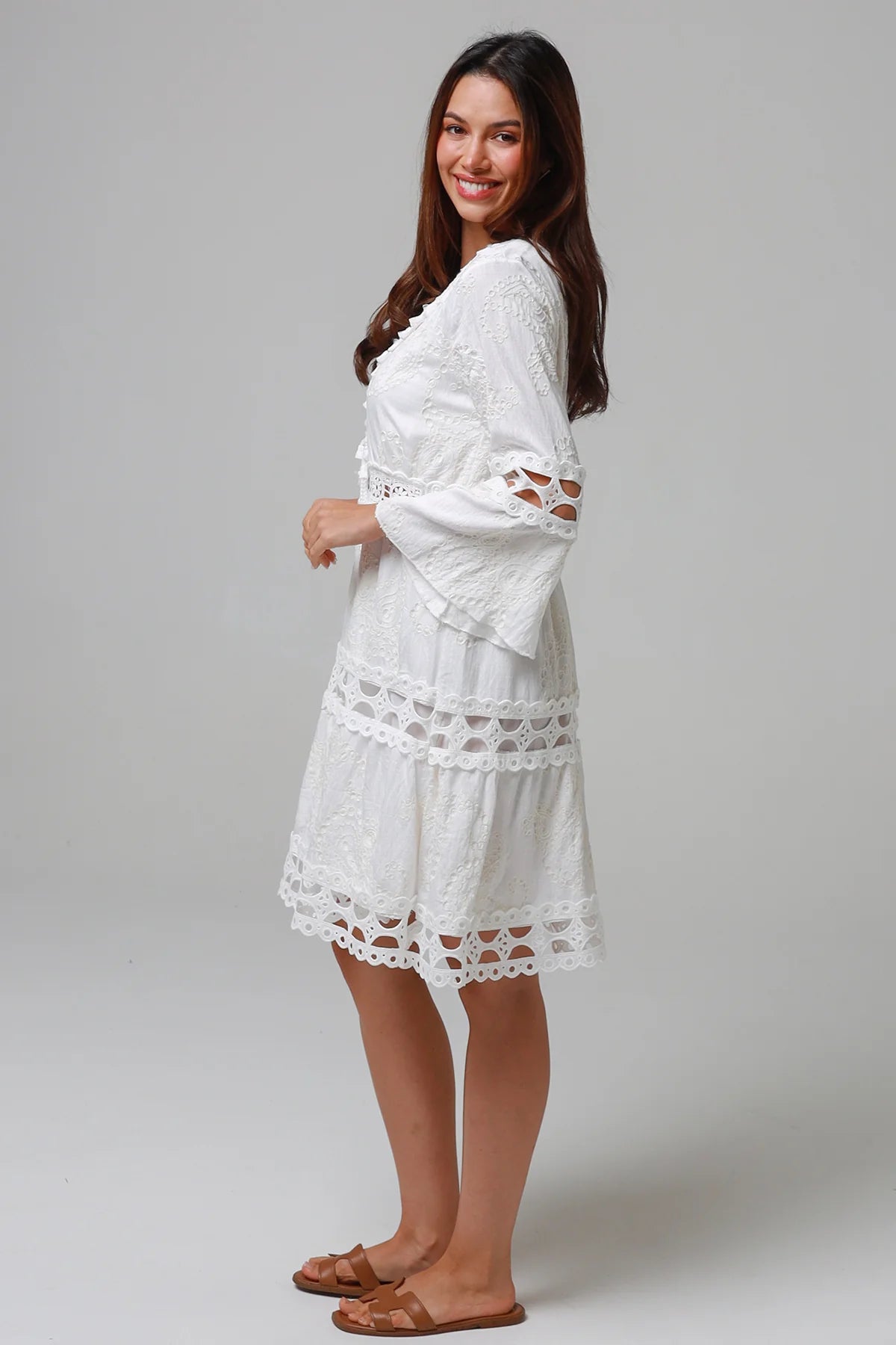 Woman in white embroidered cotton mini dress wit lace sleeves and tiered hem - Sabrina Mini Dress Bohemian Love Runway