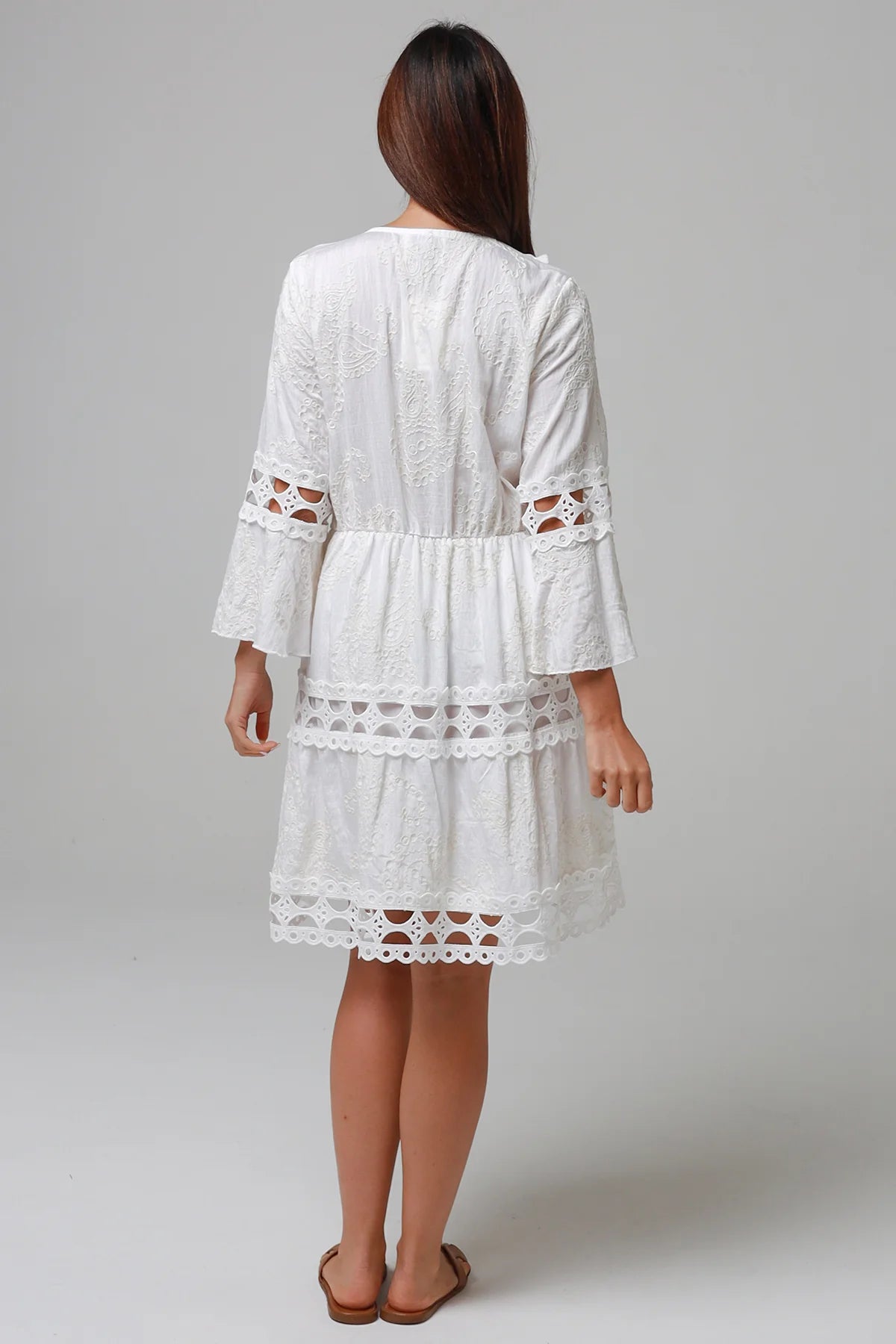 Woman in white embroidered cotton mini dress wit lace sleeves and tiered hem - Sabrina Mini Dress Bohemian Love Runway