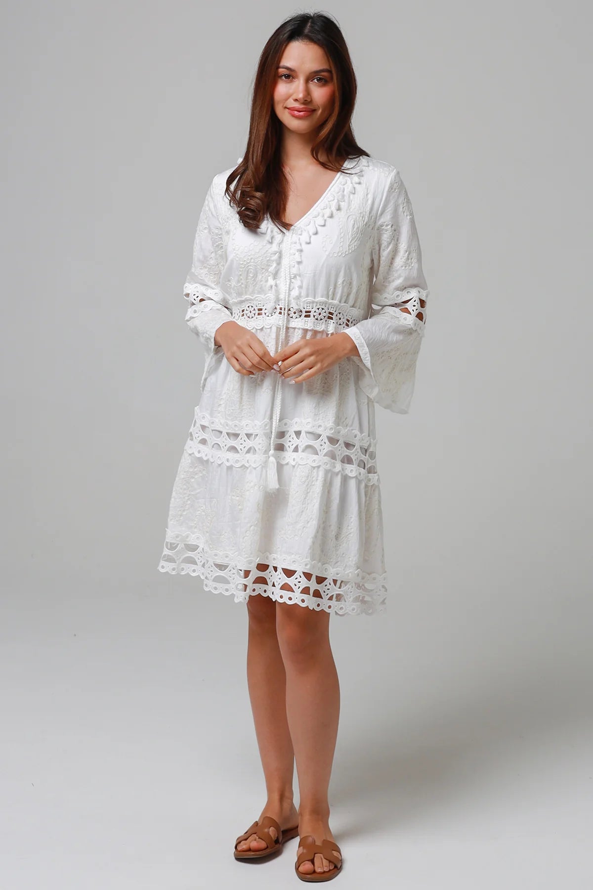 Woman in white embroidered cotton mini dress wit lace sleeves and tiered hem - Sabrina Mini Dress Bohemian Love Runway