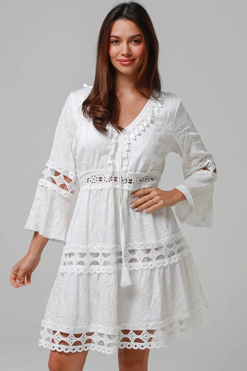 Woman in white embroidered cotton mini dress wit lace sleeves and tiered hem - Sabrina Mini Dress Bohemian Love Runway