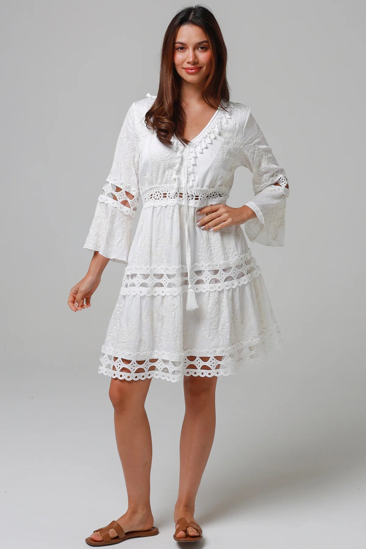 Woman in white embroidered cotton mini dress wit lace sleeves and tiered hem - Sabrina Mini Dress Bohemian Love Runway