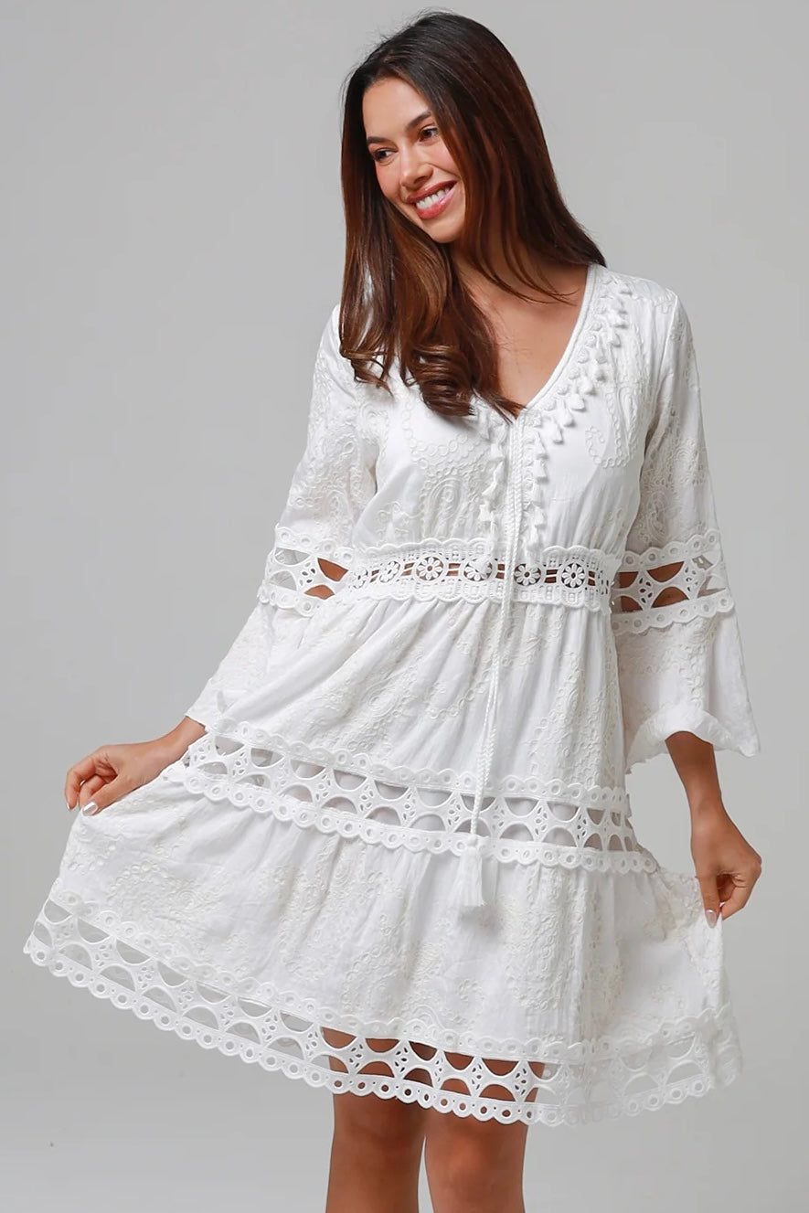 Woman in white embroidered cotton mini dress wit lace sleeves and tiered hem - Sabrina Mini Dress Bohemian Love Runway