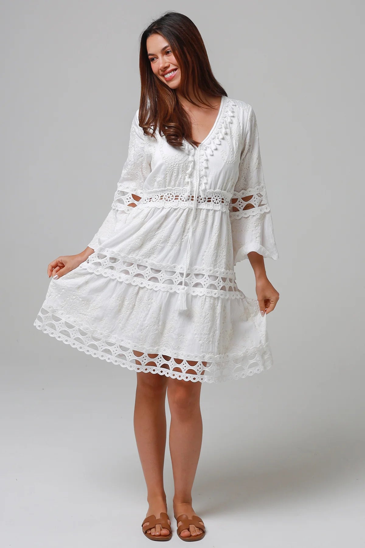 Woman in white embroidered cotton mini dress wit lace sleeves and tiered hem - Sabrina Mini Dress Bohemian Love Runway