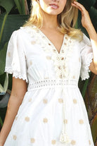 White cotton maxi dress with warm beige embroidery and scalloped embroidered hemline.