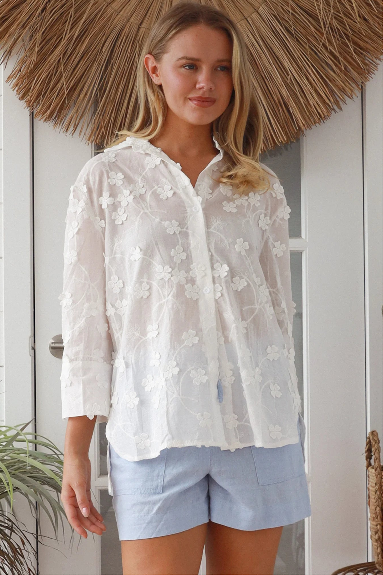 “Woman in white embroidered cotton button-down shirt with floral detailing – boho shirts Australia”
