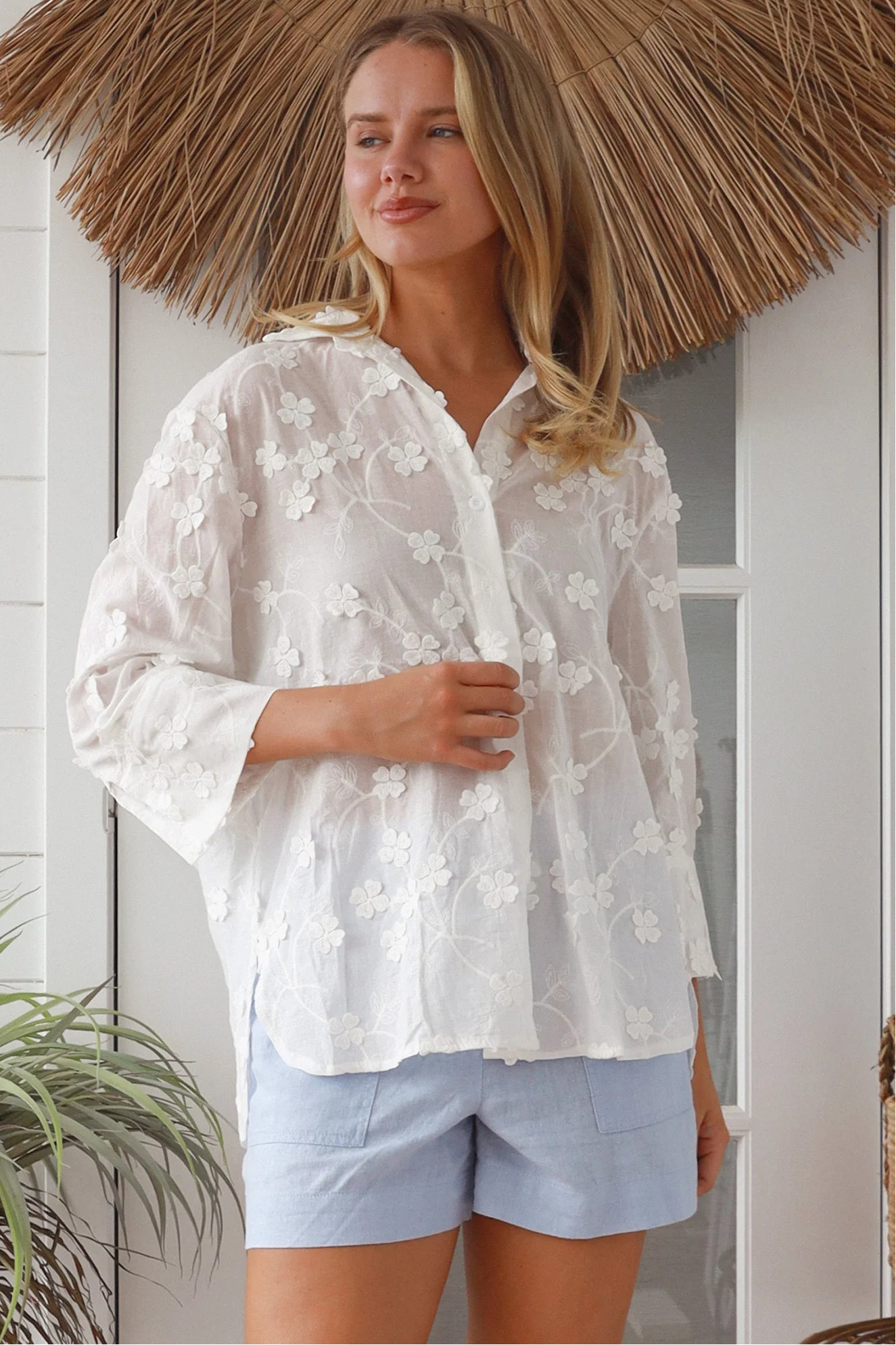 “Woman in white embroidered cotton button-down shirt with floral detailing – boho shirts Australia”