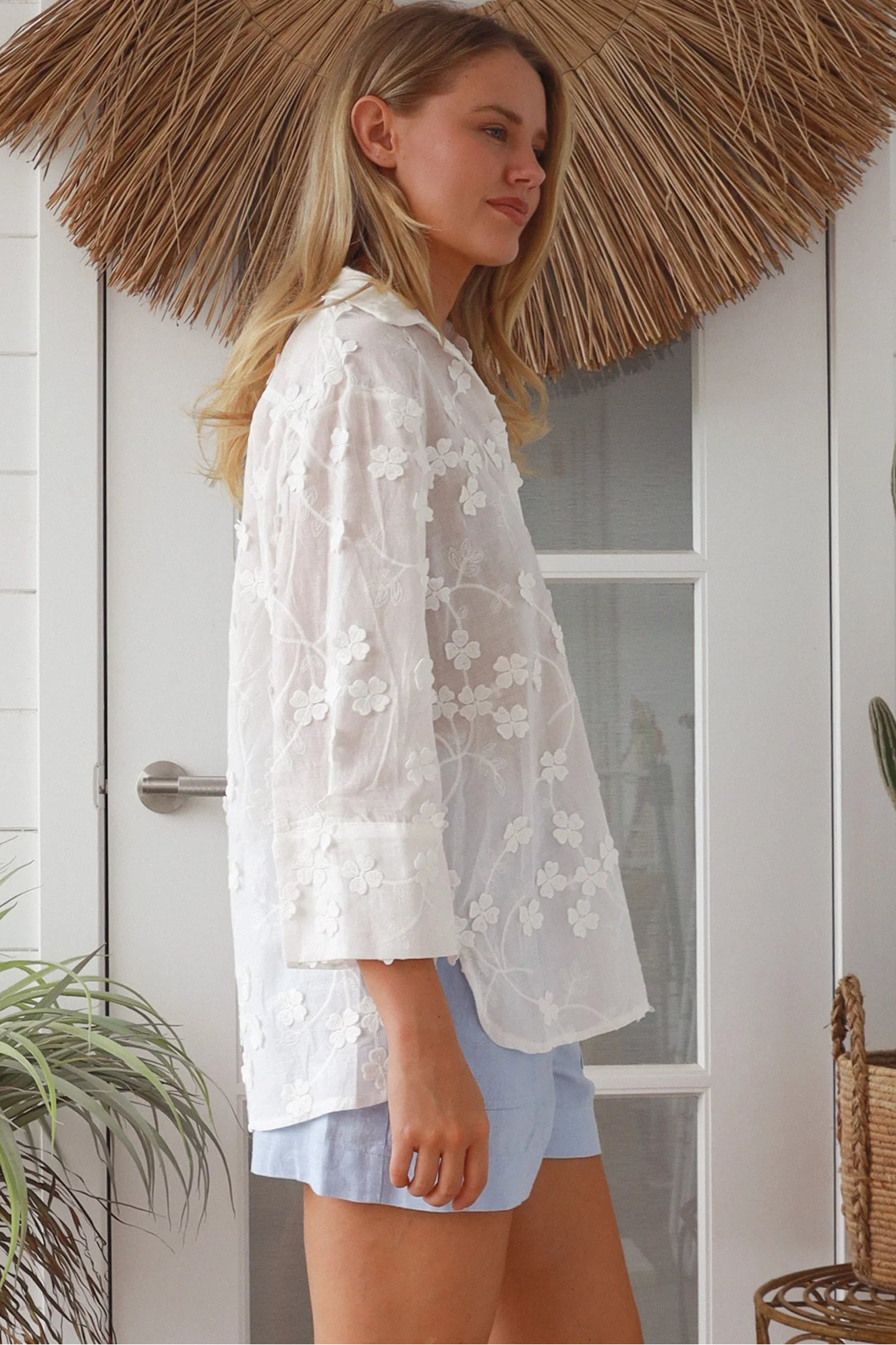 “Woman in white embroidered cotton button-down shirt with floral detailing – boho shirts Australia”