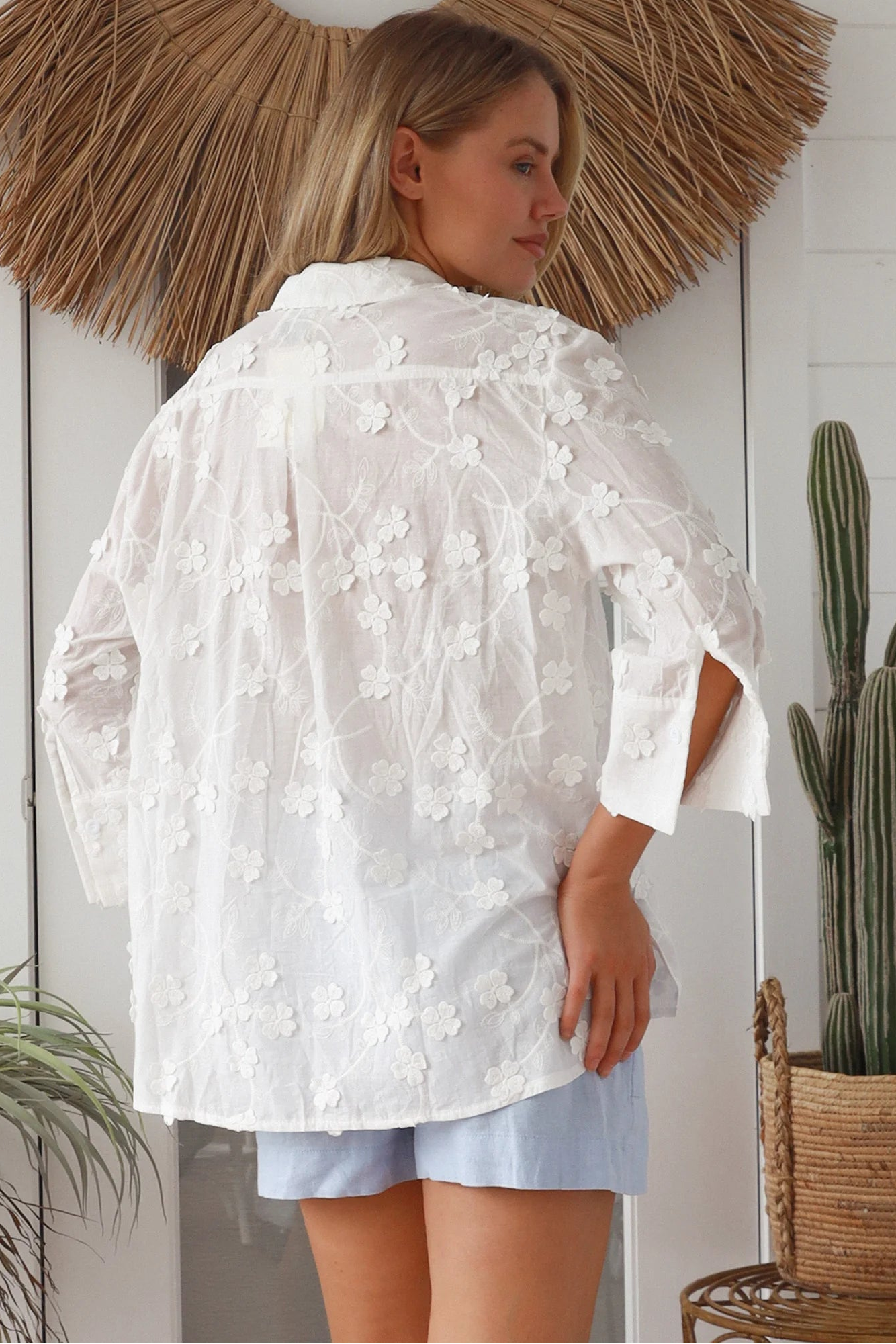 “Woman in white embroidered cotton button-down shirt with floral detailing – boho shirts Australia”