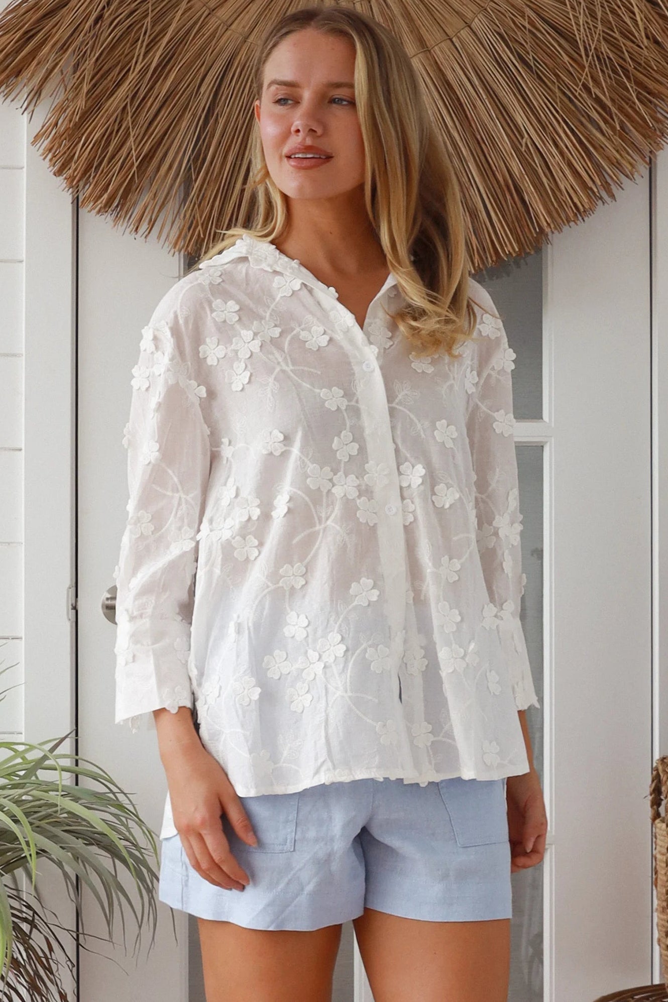 “Woman in white embroidered cotton button-down shirt with floral detailing – boho shirts Australia”