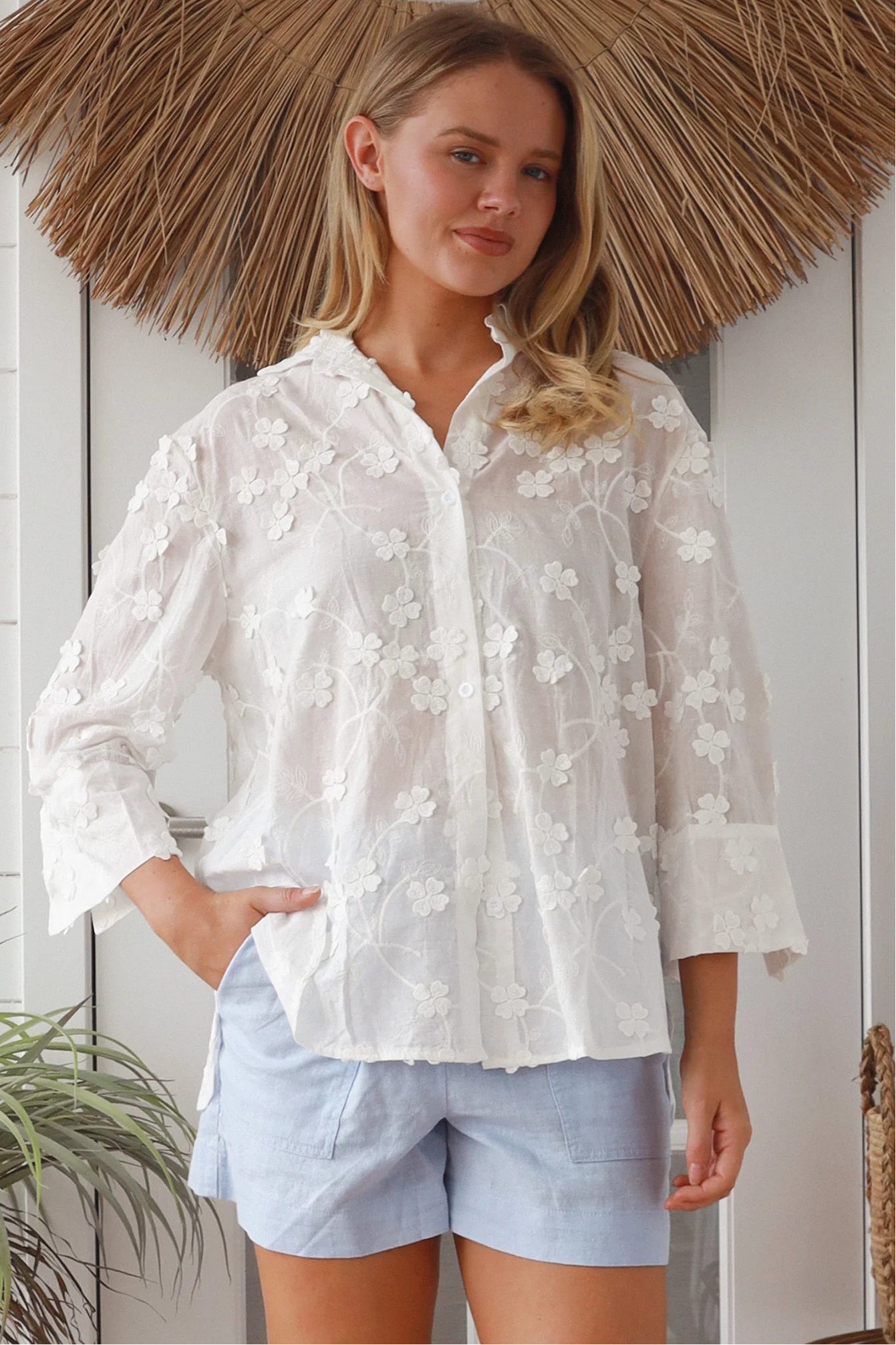 “Woman in white embroidered cotton button-down shirt with floral detailing – boho shirts Australia”