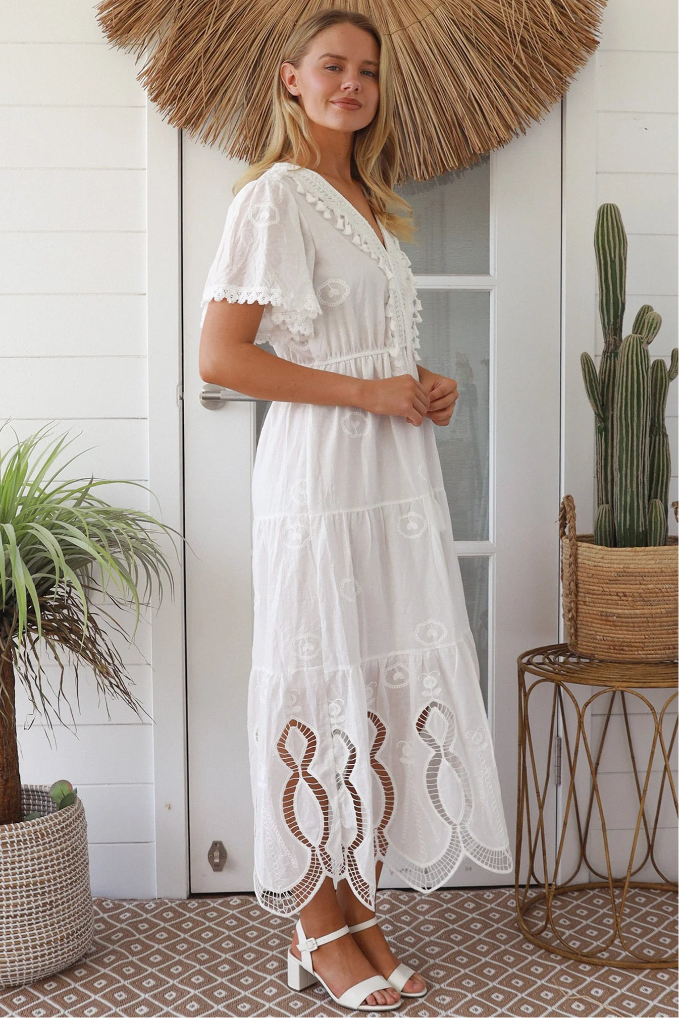 Woman in white embroidered cotton maxi dress with lace sleeves and tiered hem – Boho Maxi Dress Australia