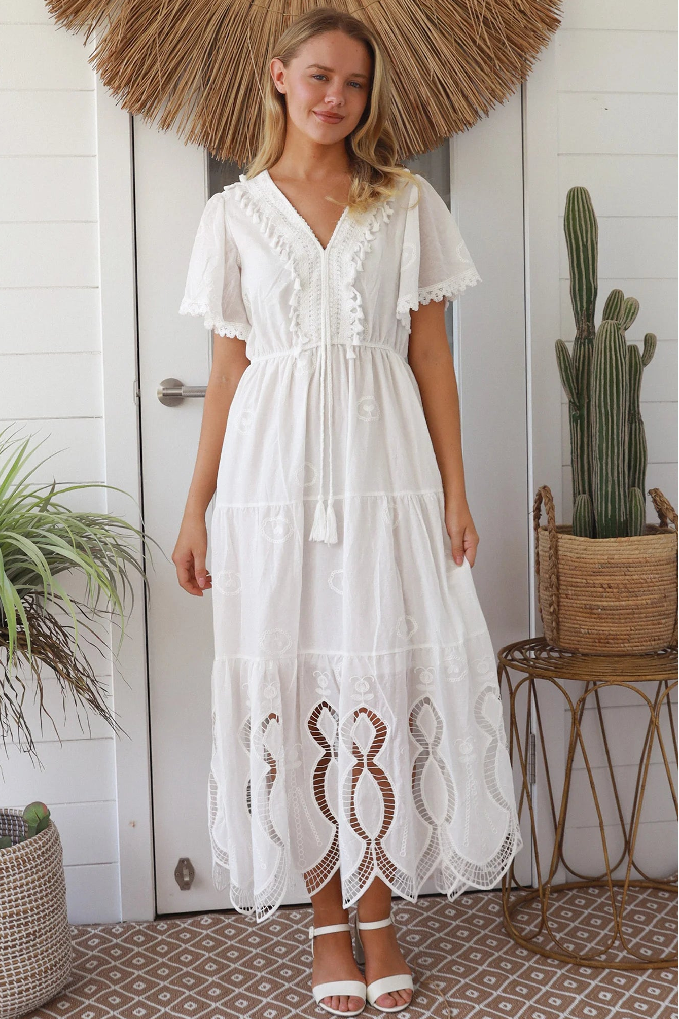 Woman in white embroidered cotton maxi dress with lace sleeves and tiered hem – Boho Maxi Dress Australia