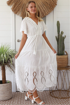 Woman in white embroidered cotton maxi dress with lace sleeves and tiered hem – Boho Maxi Dress Australia
