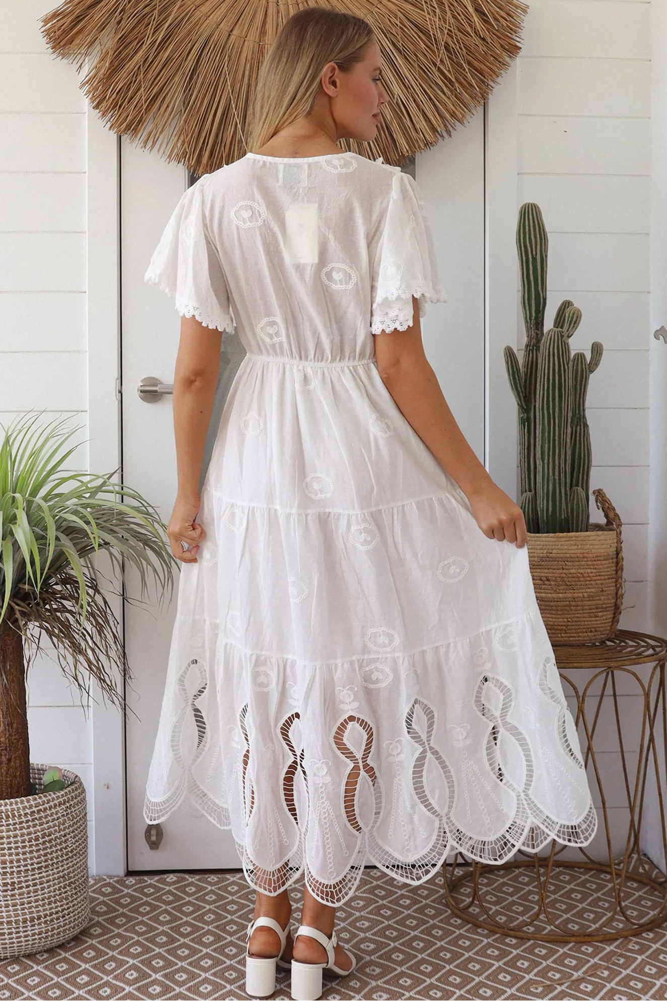 Woman in white embroidered cotton maxi dress with lace sleeves and tiered hem – Boho Maxi Dress Australia