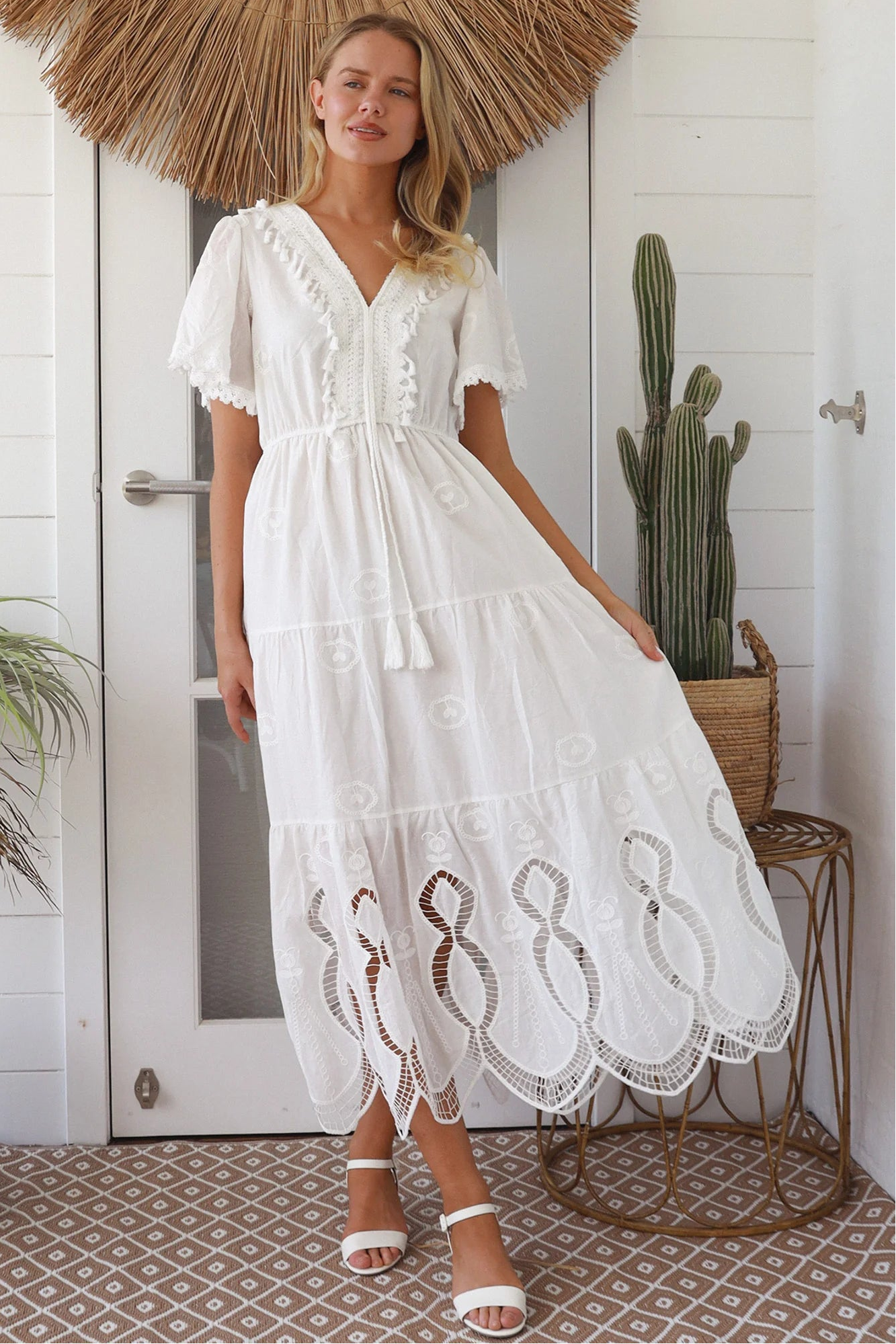 Woman in white embroidered cotton maxi dress with lace sleeves and tiered hem – Boho Maxi Dress Australia