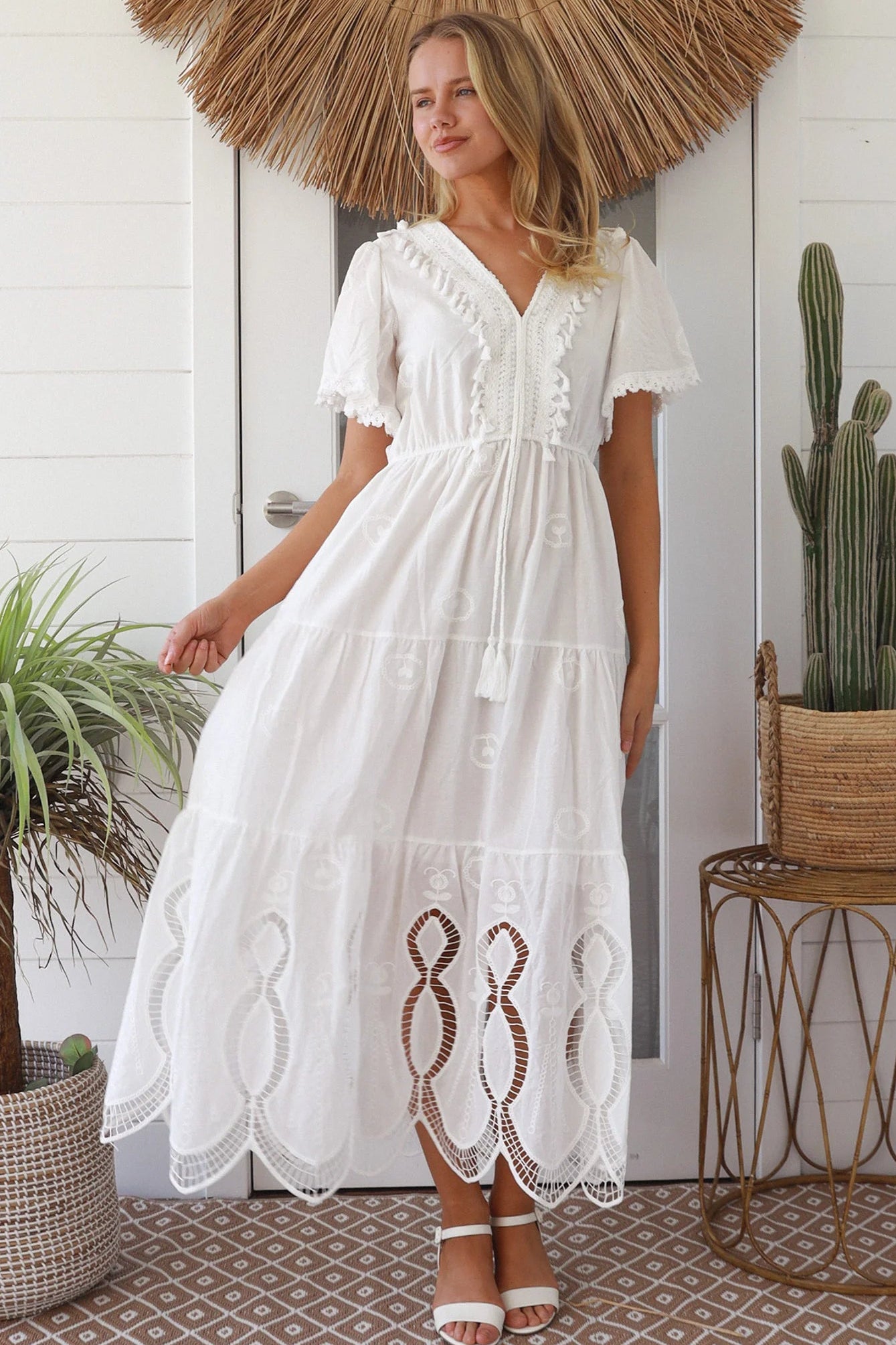 Woman in white embroidered cotton maxi dress with lace sleeves and tiered hem – Boho Maxi Dress Australia
