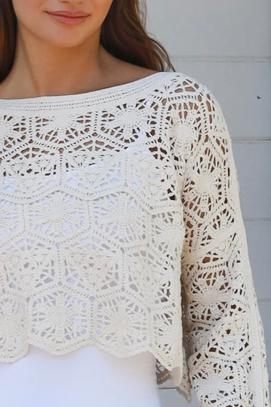 Cream crochet cotton long sleeve crop top with scalloped hem and flared cuffs styled with white shorts