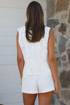 White cotton embroidered sleeveless vest with button front styled for Australian summer boho fashion