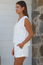White cotton embroidered sleeveless vest with button front styled for Australian summer boho fashion