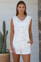 White cotton embroidered sleeveless vest with button front styled for Australian summer boho fashion