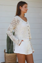Cream floral crochet cardigan with scalloped sleeves and button-front V-neck styling — boho knitwear Australia