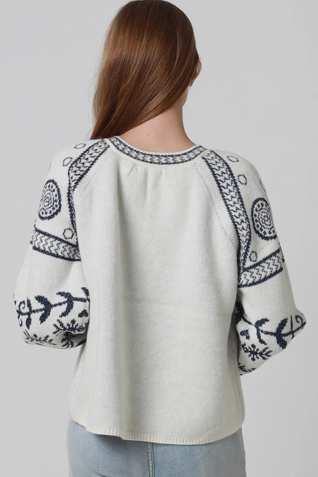 Woman wearing cream boho knit jumper with navy lurex detailing balloon sleeves textured winter styling and relaxed bohemian knitwear Australia
