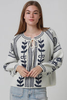 Woman wearing cream boho knit jumper with navy lurex detailing balloon sleeves textured winter styling and relaxed bohemian knitwear Australia