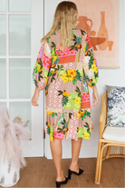 “Woman in a tropical bamboo patchwork boho midi dress with mandarin collar and belt – sustainable bohemian clothing Australia”