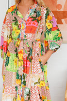 “Woman in a tropical bamboo patchwork boho midi dress with mandarin collar and belt – sustainable bohemian clothing Australia”