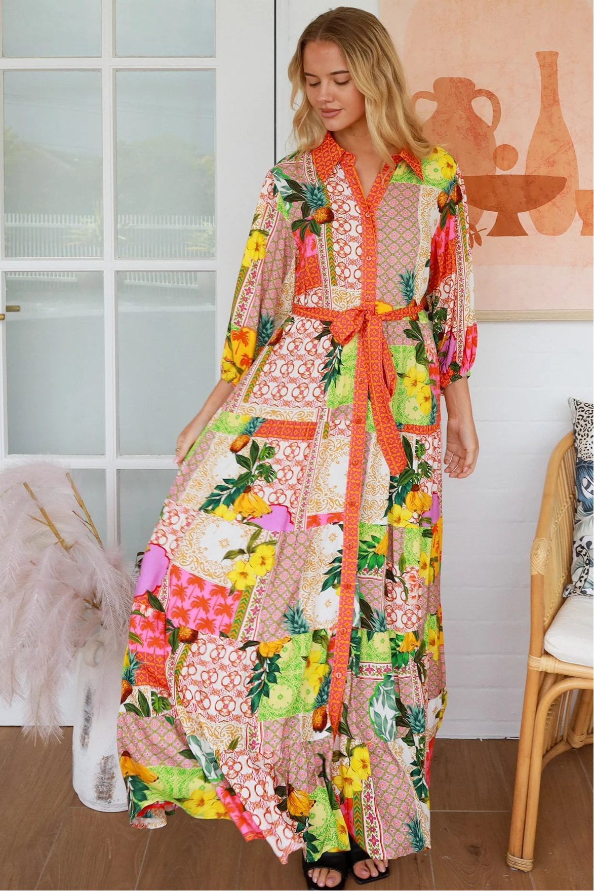 “Woman in tropical patchwork bamboo rayon boho maxi dress with red collar and tie belt — sustainable bohemian fashion Australia.”