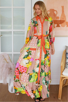“Woman in tropical patchwork bamboo rayon boho maxi dress with red collar and tie belt — sustainable bohemian fashion Australia.”