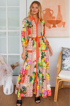 “Woman in tropical patchwork bamboo rayon boho maxi dress with red collar and tie belt — sustainable bohemian fashion Australia.”