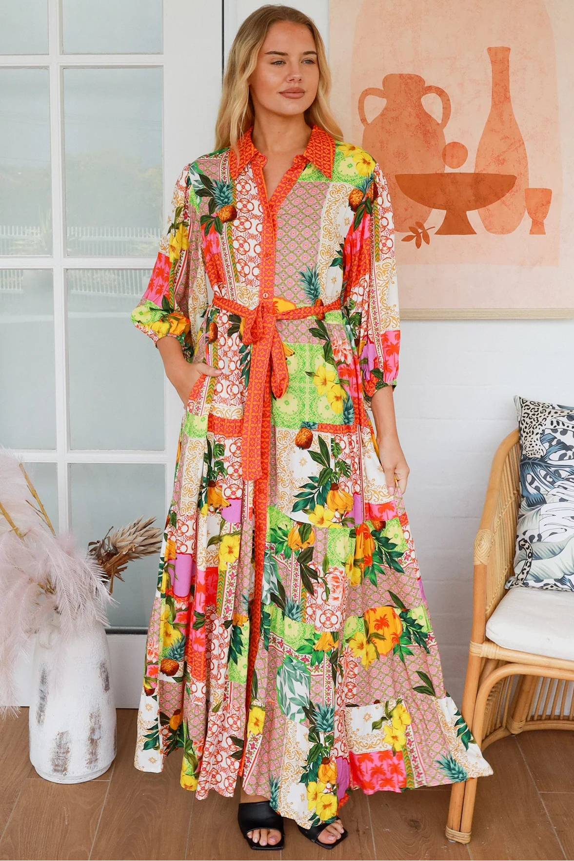 “Woman in tropical patchwork bamboo rayon boho maxi dress with red collar and tie belt — sustainable bohemian fashion Australia.”