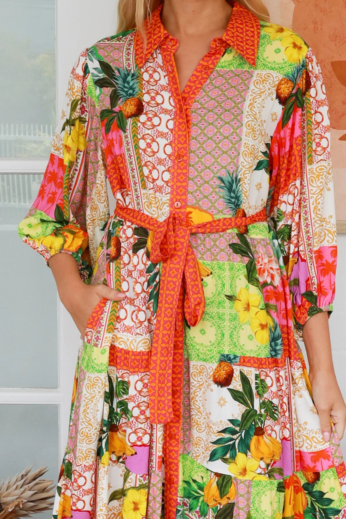 “Woman in tropical patchwork bamboo rayon boho maxi dress with red collar and tie belt — sustainable bohemian fashion Australia.”