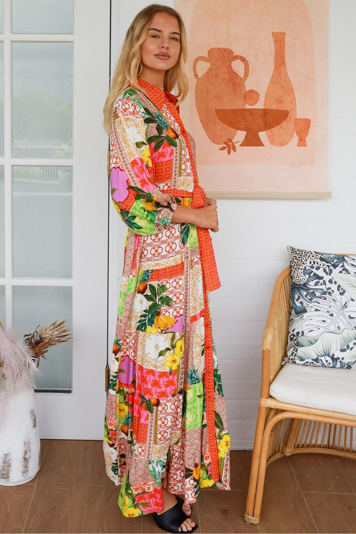 “Woman in tropical patchwork bamboo rayon boho maxi dress with red collar and tie belt — sustainable bohemian fashion Australia.”